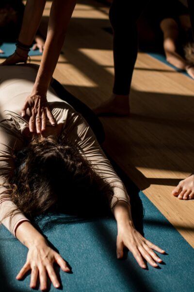 Student in a restorative pose, during a sunny Restorative Yoga session