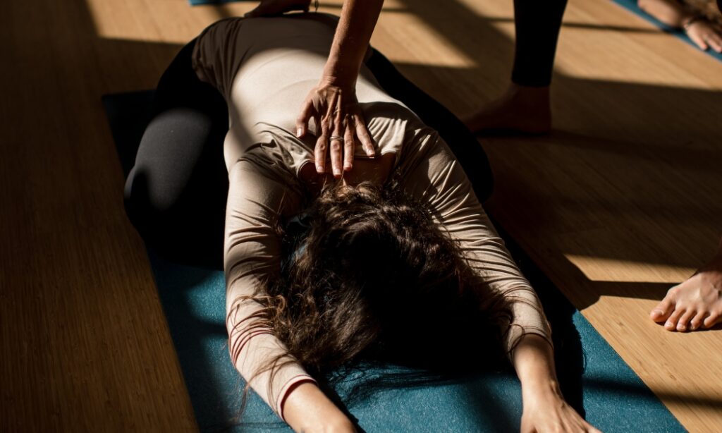 Student in a restorative pose, during a sunny Restorative Yoga session