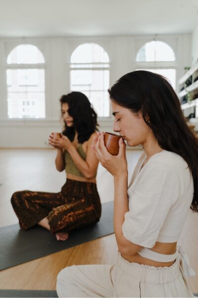 Women drinking cacao during a ceremony at De Nieuwe Yogaschool
