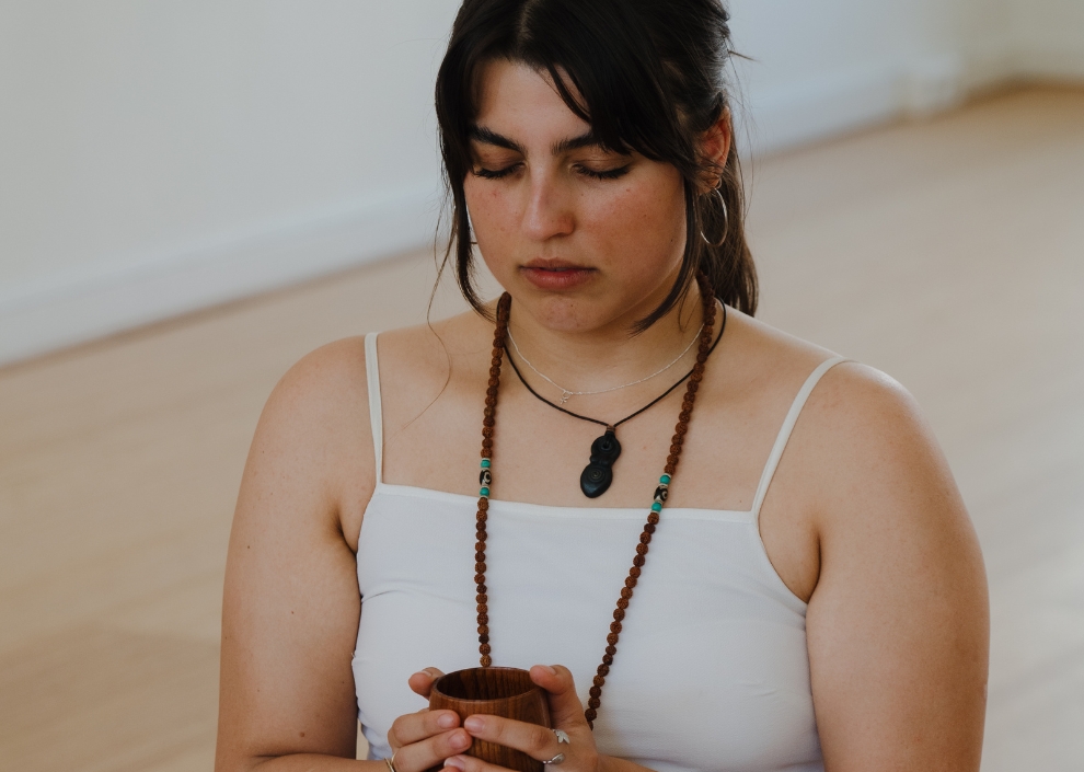 Woman drinking cacao during a ceremony at De Nieuwe Yogaschool