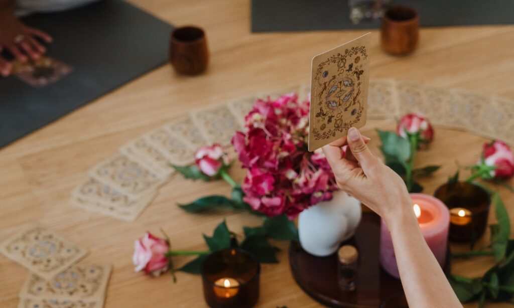 Ceremony participant holding up an oracle card as part of a Women's Ceremony