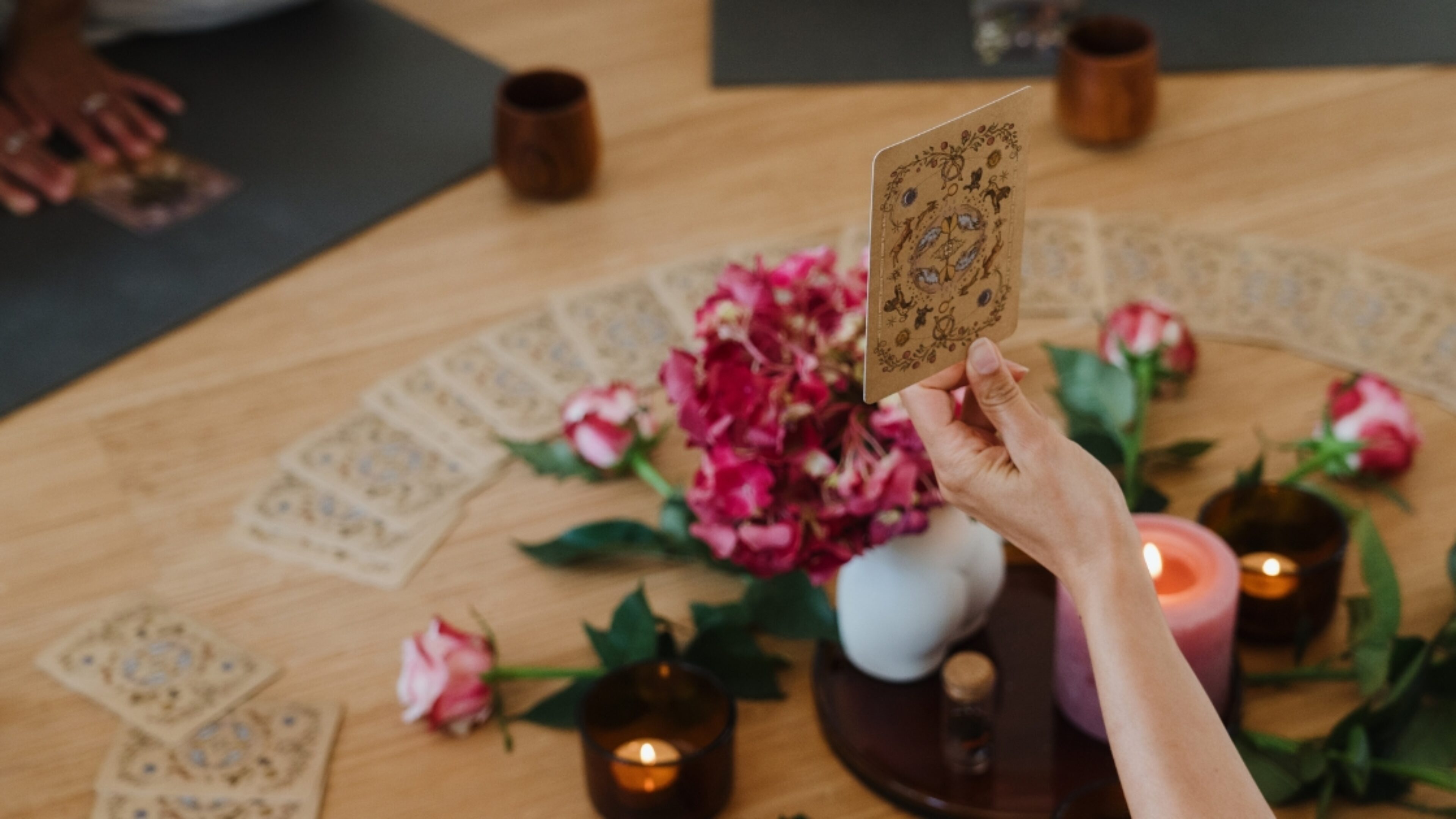Ceremony participant holding up an oracle card as part of a Women's Ceremony