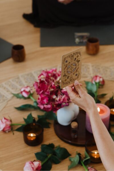 Ceremony participant holding up an oracle card as part of a Women's Ceremony