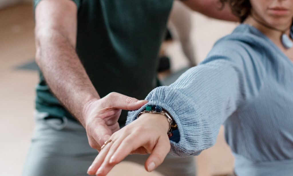 Student in a Vinyasa pose being adjusted by DNYS Academie teacher Johan Noorloos