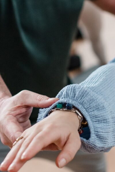 Student in a Vinyasa pose being adjusted by DNYS Academie teacher Johan Noorloos