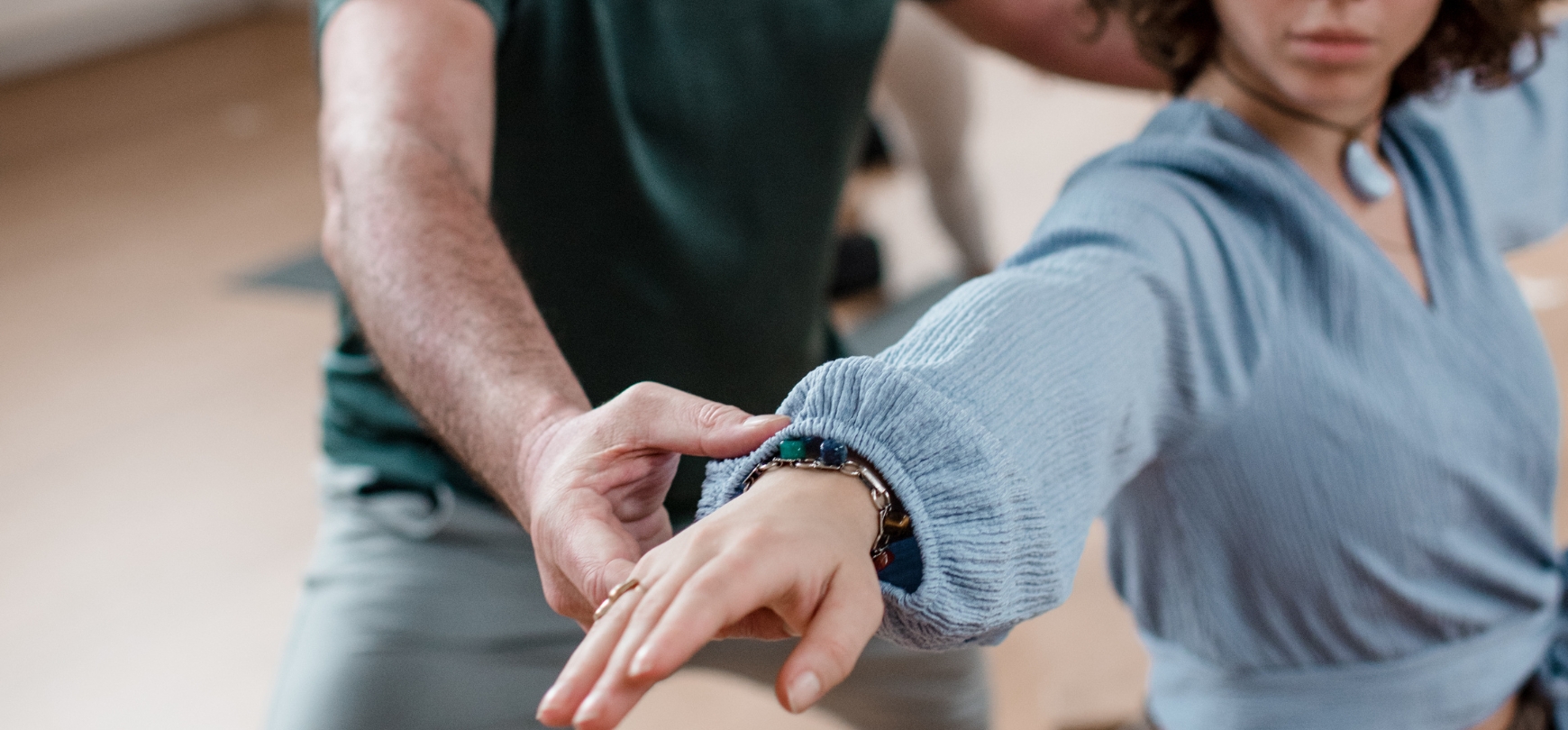Student in a Vinyasa pose being adjusted by DNYS Academie teacher Johan Noorloos