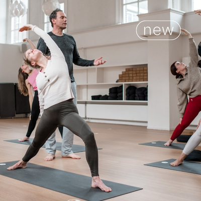Students in yoga poses during a Vinyasa class at De Nieuwe Yogaschool